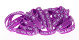 "Play Chess Like A Girl" purple Silicone Wristbands bunched together.