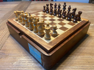 Picture of Rosewood magnetic set with chess pieces on board.